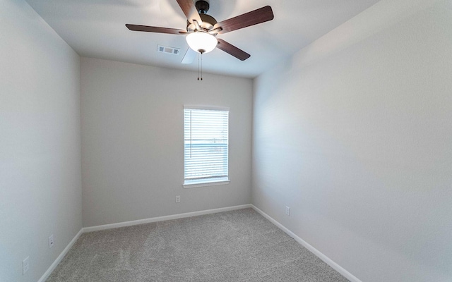 spare room featuring carpet flooring and ceiling fan