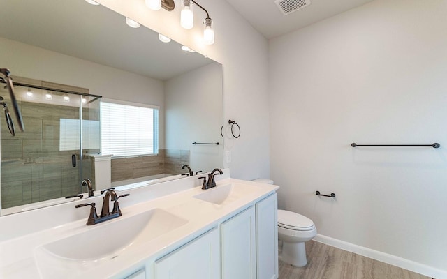 full bathroom featuring toilet, hardwood / wood-style floors, vanity, and shower with separate bathtub