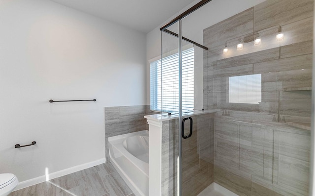 bathroom with shower with separate bathtub and toilet