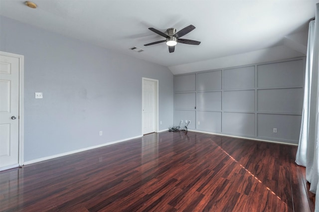 empty room featuring ceiling fan, dark hardwood / wood-style flooring, and lofted ceiling