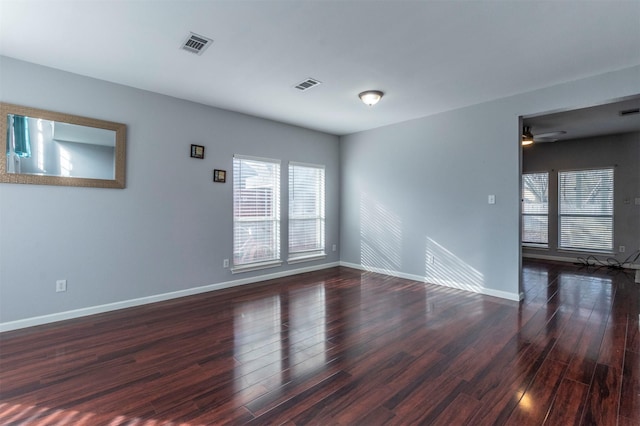 unfurnished room featuring ceiling fan and dark hardwood / wood-style flooring