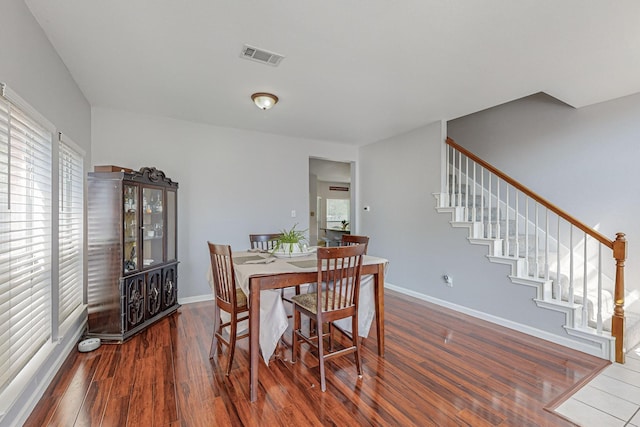 dining space featuring dark wood-type flooring