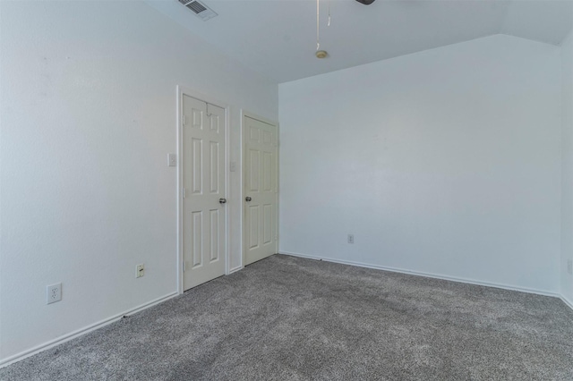 carpeted spare room with ceiling fan and vaulted ceiling