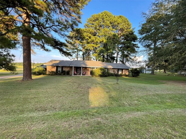 ranch-style home with a front lawn