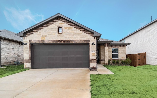 french country inspired facade with driveway, stone siding, an attached garage, fence, and a front lawn