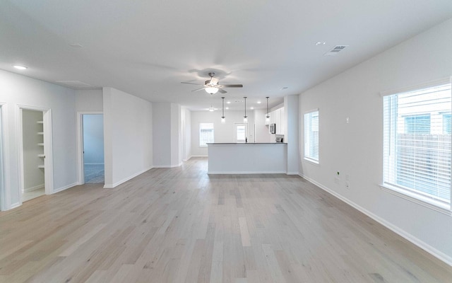 unfurnished living room featuring baseboards, visible vents, a ceiling fan, light wood-type flooring, and recessed lighting