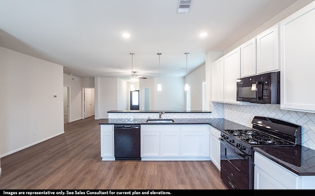 kitchen featuring black appliances, kitchen peninsula, sink, and light hardwood / wood-style floors