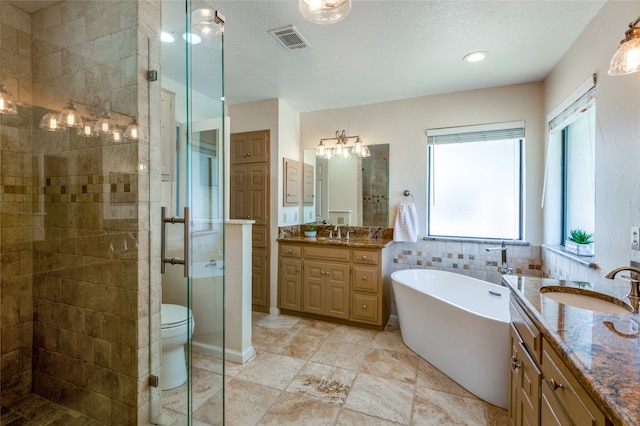 full bathroom featuring plus walk in shower, a textured ceiling, toilet, vanity, and tile walls