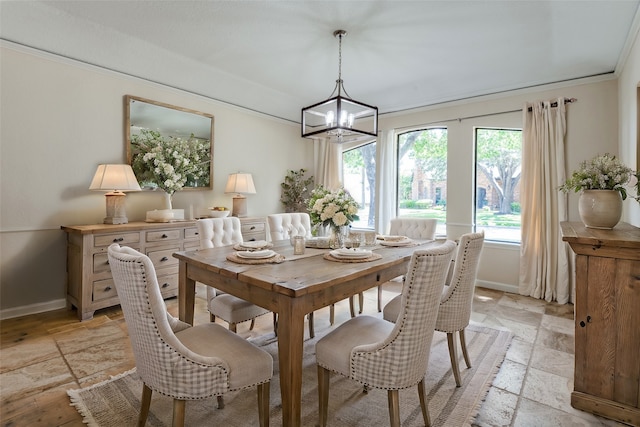 dining space featuring a chandelier and ornamental molding