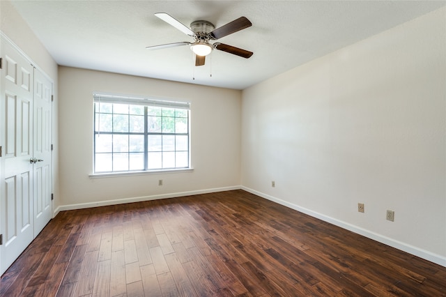 unfurnished room featuring dark hardwood / wood-style flooring and ceiling fan