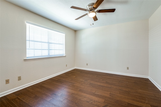 unfurnished room featuring ceiling fan and dark wood-type flooring