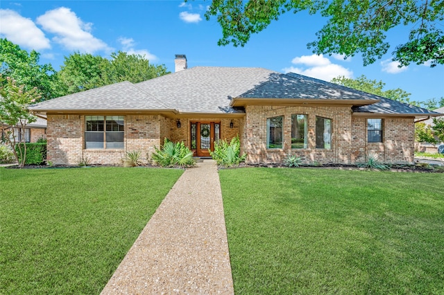 single story home featuring a front lawn