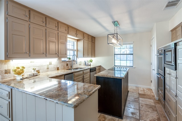 kitchen with a wealth of natural light, a center island, pendant lighting, and sink