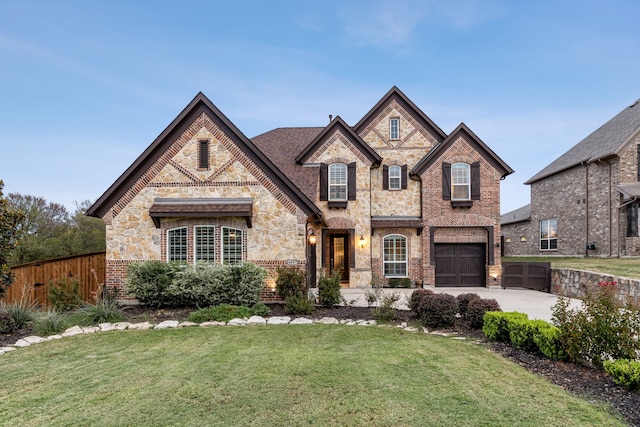 view of front of home with a front yard and a garage