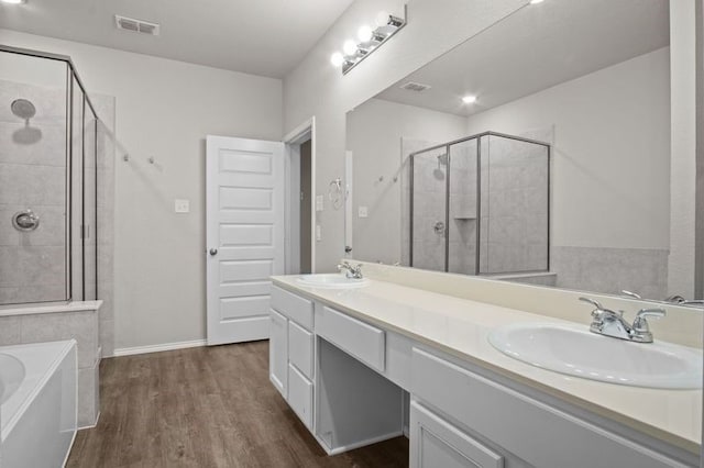 bathroom with vanity, separate shower and tub, and wood-type flooring