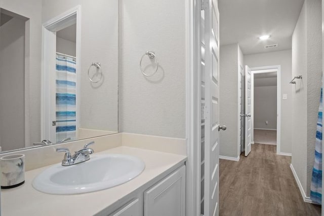 bathroom with vanity and wood-type flooring