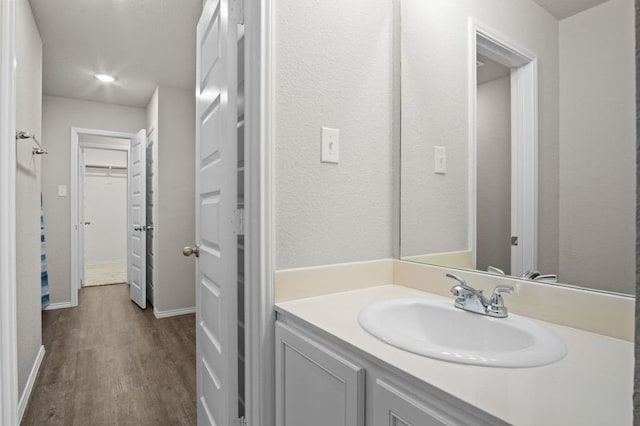 bathroom featuring vanity and wood-type flooring