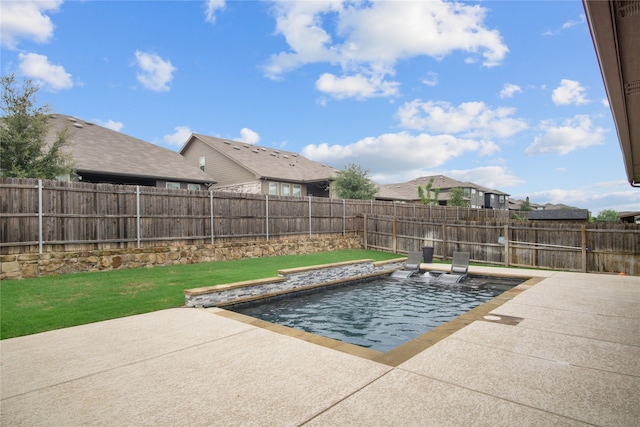 view of pool with a lawn and a patio