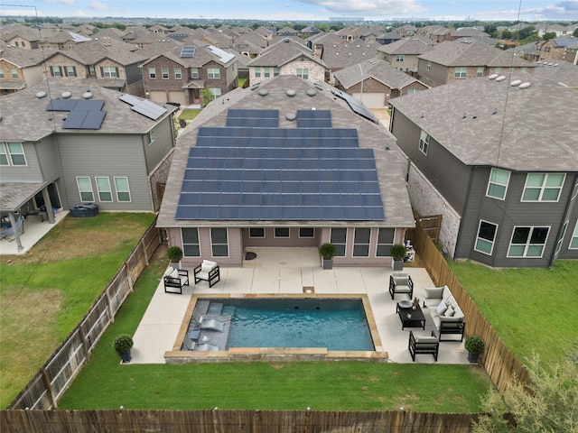 back of property with an outdoor living space, a patio area, and solar panels