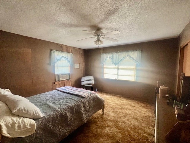 bedroom featuring a textured ceiling, ceiling fan, cooling unit, and carpet floors