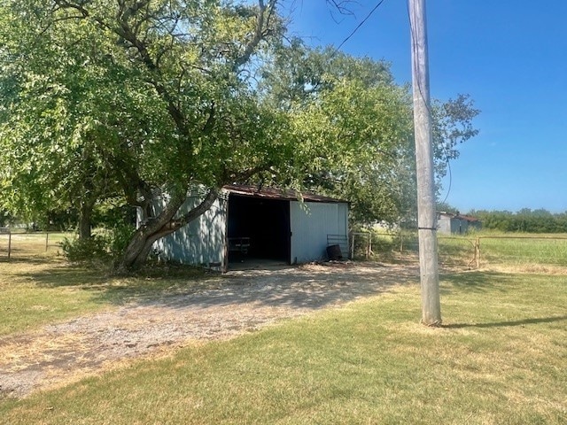 view of outbuilding featuring a yard