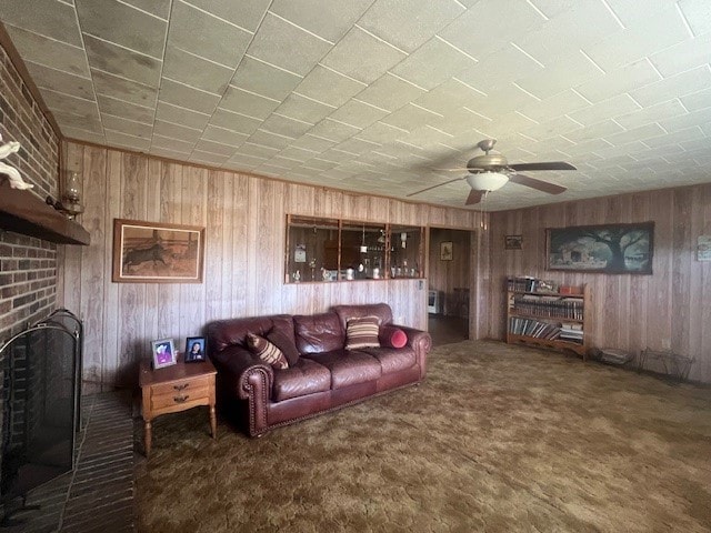 living room featuring dark carpet and wood walls