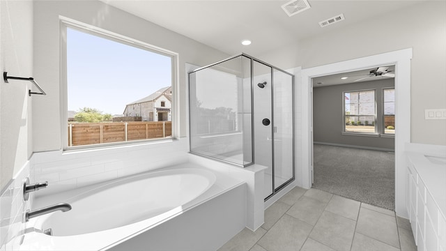 bathroom featuring ceiling fan, tile patterned floors, separate shower and tub, and sink