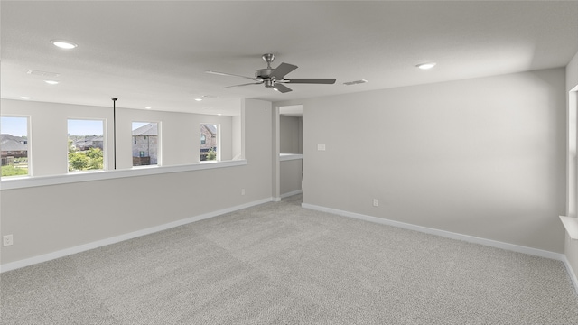 spare room featuring ceiling fan and carpet floors