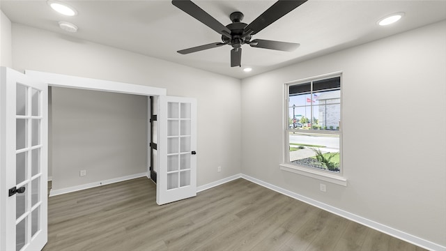 spare room featuring ceiling fan, french doors, and wood-type flooring