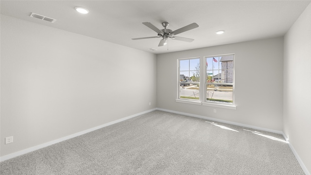 spare room with carpet and ceiling fan