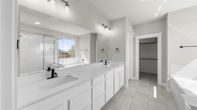 bathroom with separate shower and tub, vanity, and tile patterned floors