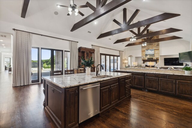 kitchen with a large island, a ceiling fan, arched walkways, dark brown cabinetry, and appliances with stainless steel finishes