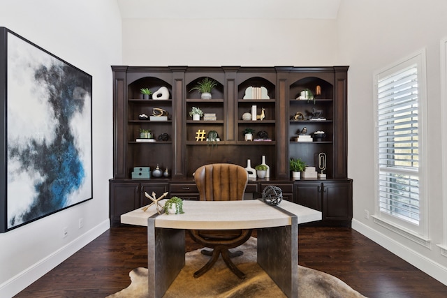 home office featuring a healthy amount of sunlight, dark wood-style flooring, and baseboards