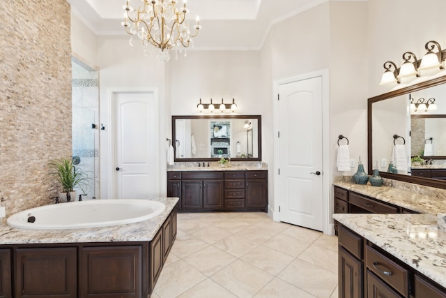 full bath featuring a chandelier, a washtub, two vanities, a tile shower, and ornamental molding