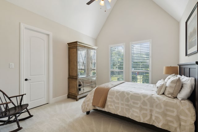 bedroom with baseboards, light carpet, high vaulted ceiling, and ceiling fan