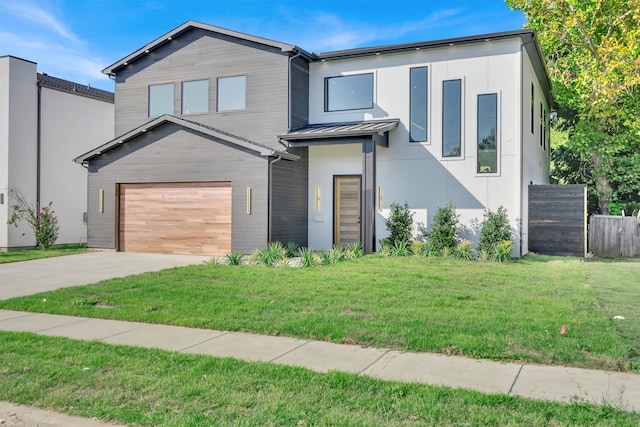 contemporary house featuring a garage and a front yard