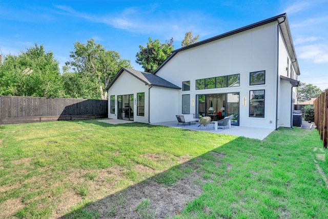 rear view of house with a yard and a patio area