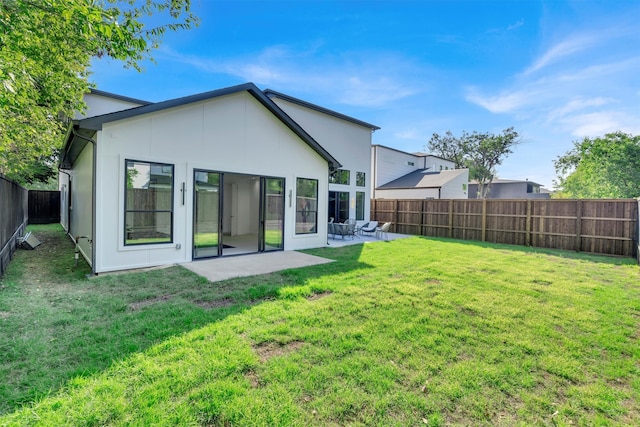 back of house with a yard and a patio area