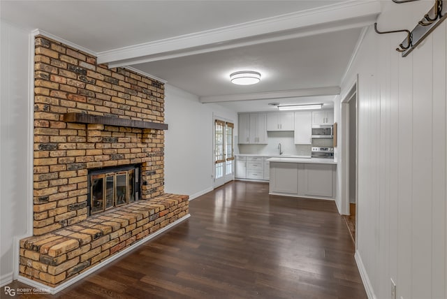 unfurnished living room with a fireplace, crown molding, dark hardwood / wood-style flooring, and beamed ceiling