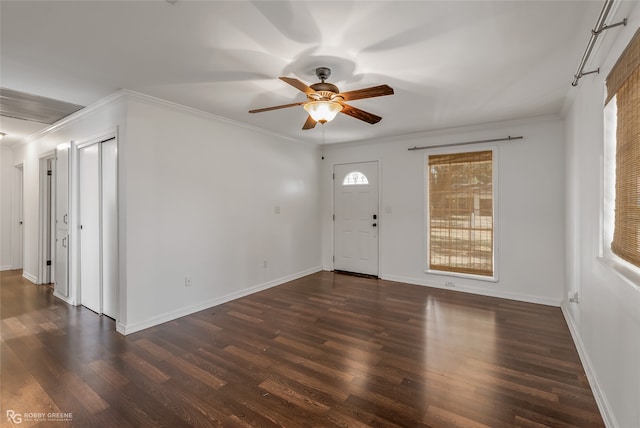 foyer entrance with crown molding, dark hardwood / wood-style flooring, and ceiling fan