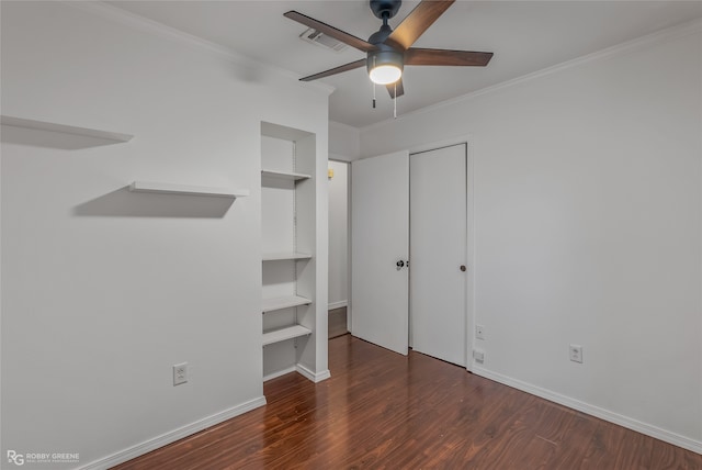 unfurnished bedroom with ornamental molding, ceiling fan, and dark hardwood / wood-style floors