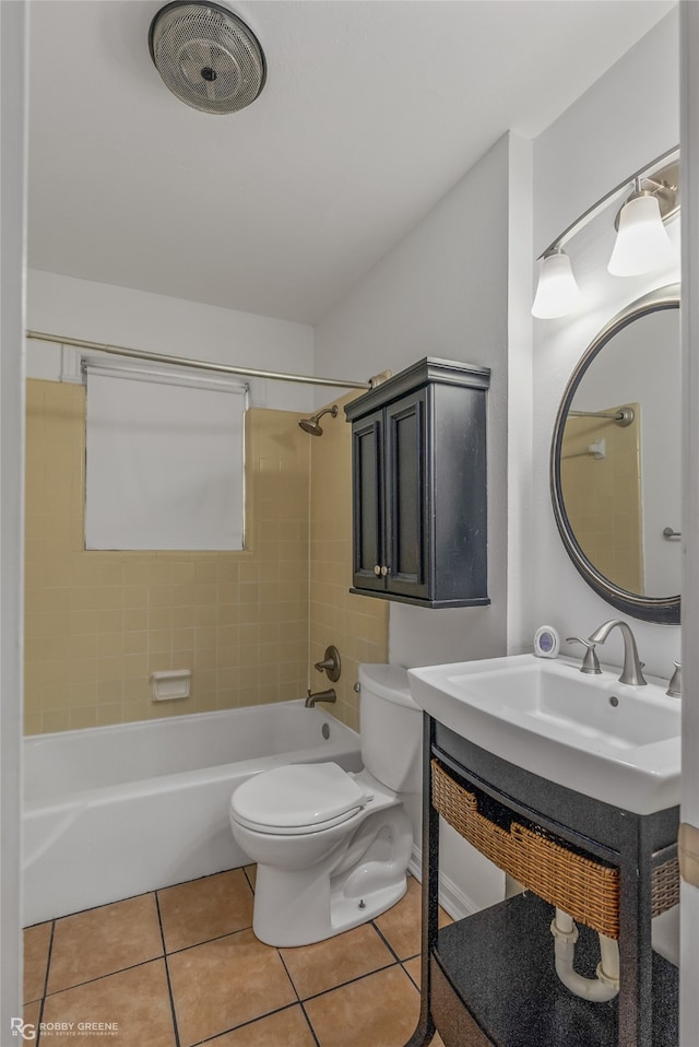 full bathroom featuring tiled shower / bath combo, vanity, toilet, and tile patterned floors