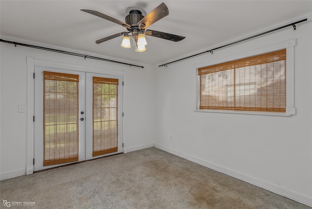 unfurnished room with light carpet, french doors, and ceiling fan