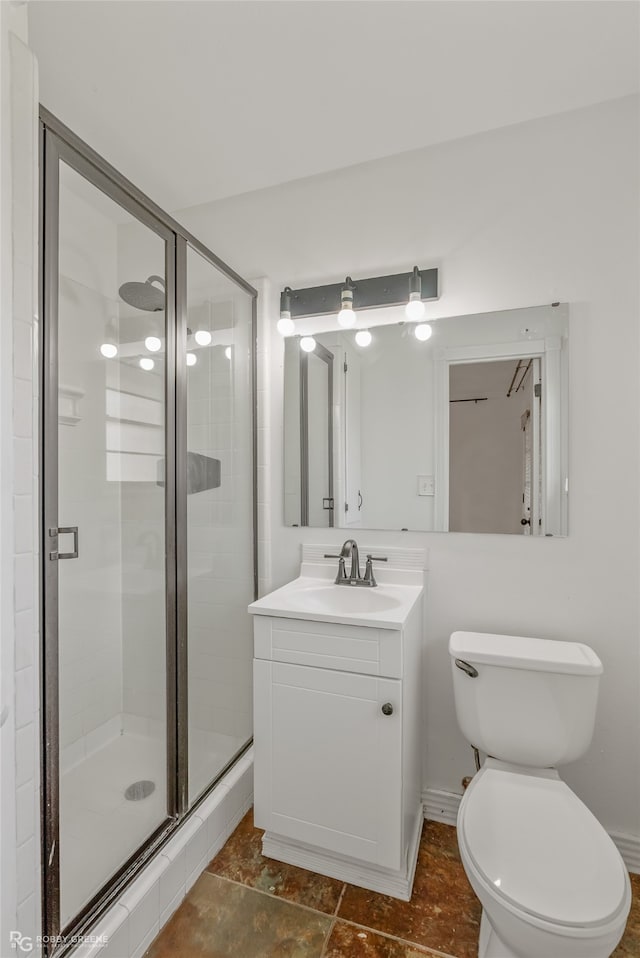 bathroom featuring tile patterned floors, toilet, an enclosed shower, and vanity