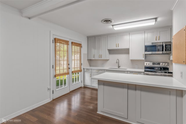 kitchen with backsplash, stainless steel appliances, sink, dark hardwood / wood-style floors, and ornamental molding