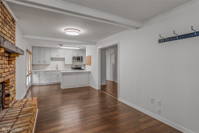 kitchen with appliances with stainless steel finishes, white cabinetry, decorative backsplash, and dark hardwood / wood-style floors