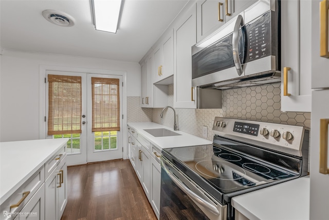 kitchen with white cabinetry, sink, appliances with stainless steel finishes, and dark hardwood / wood-style flooring