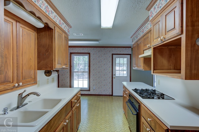 kitchen featuring crown molding, a textured ceiling, light tile patterned floors, black appliances, and sink