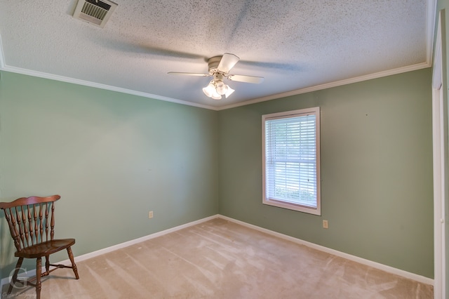 carpeted empty room with a textured ceiling, crown molding, and ceiling fan