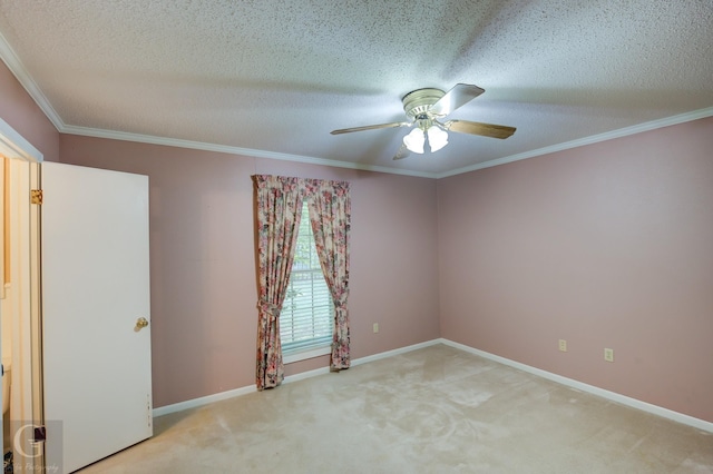 spare room featuring light carpet, crown molding, a textured ceiling, and baseboards